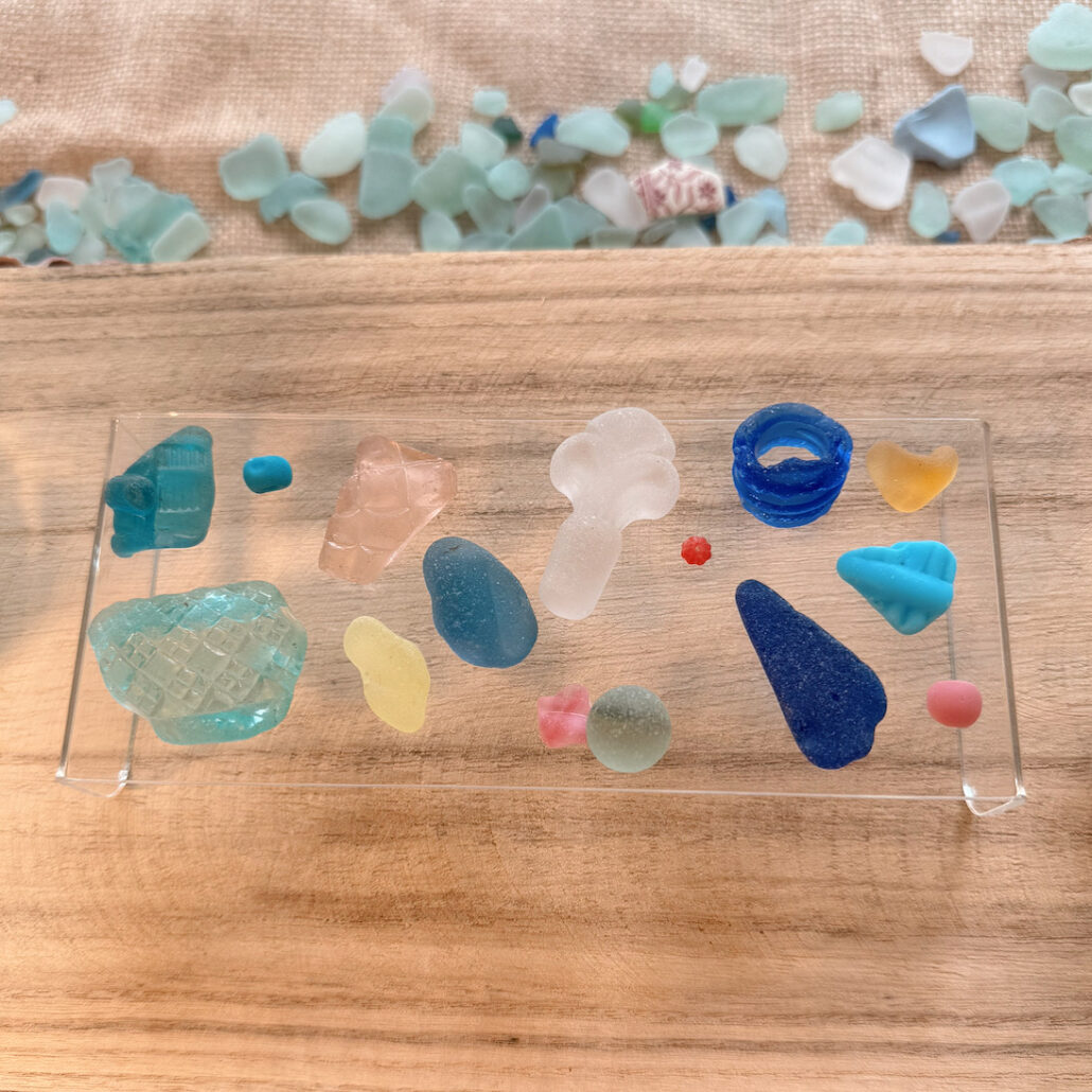 Fifteen ultimate rare, top 15 sea glass pieces from Sadie Jewellery displayed together, showcasing vibrant ocean-inspired colors and textures.