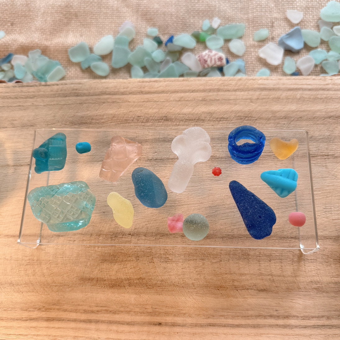 Fifteen ultimate rare, top 15 sea glass pieces from Sadie Jewellery displayed together, showcasing vibrant ocean-inspired colors and textures.